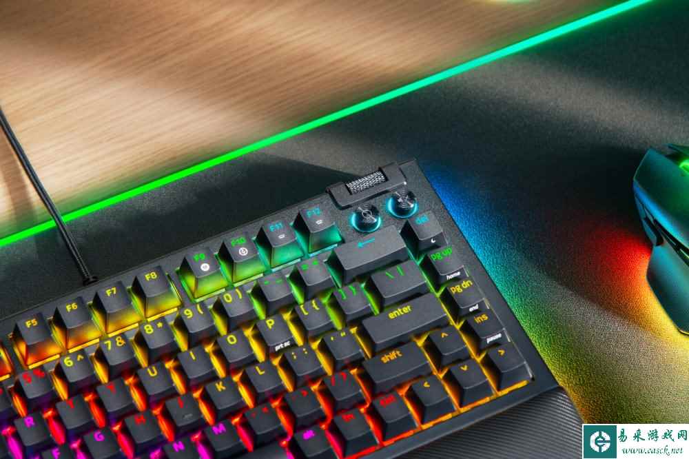 A keyboard with rainbow colored lights

Description automatically generated